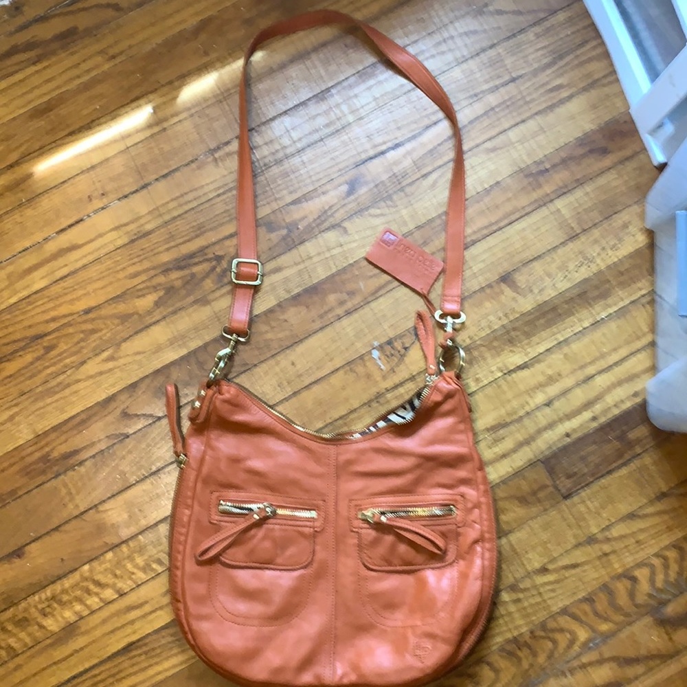 Linea Pelle Cross body added dressed coin purse.